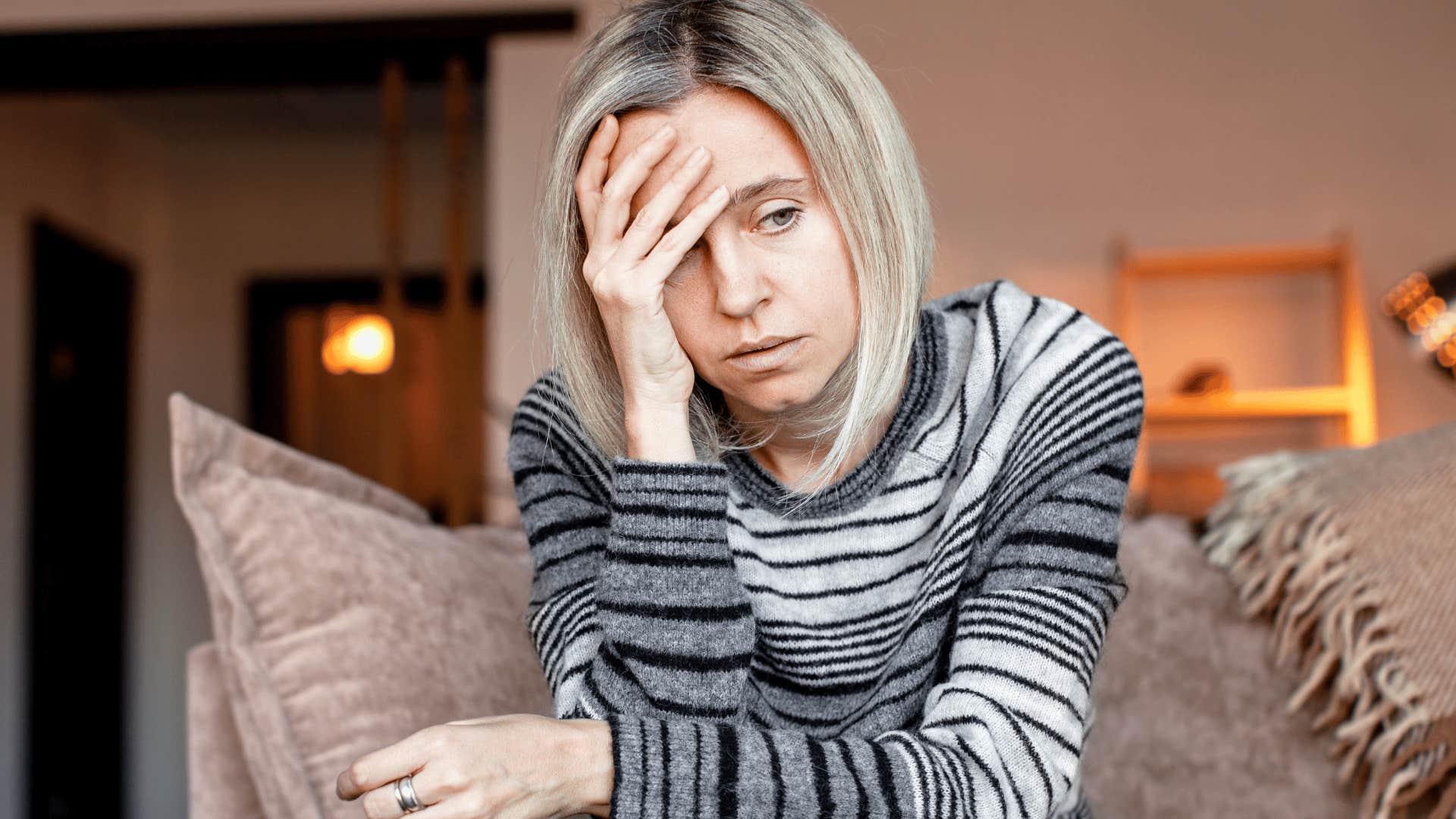 sad woman complaining about being tired sitting at home