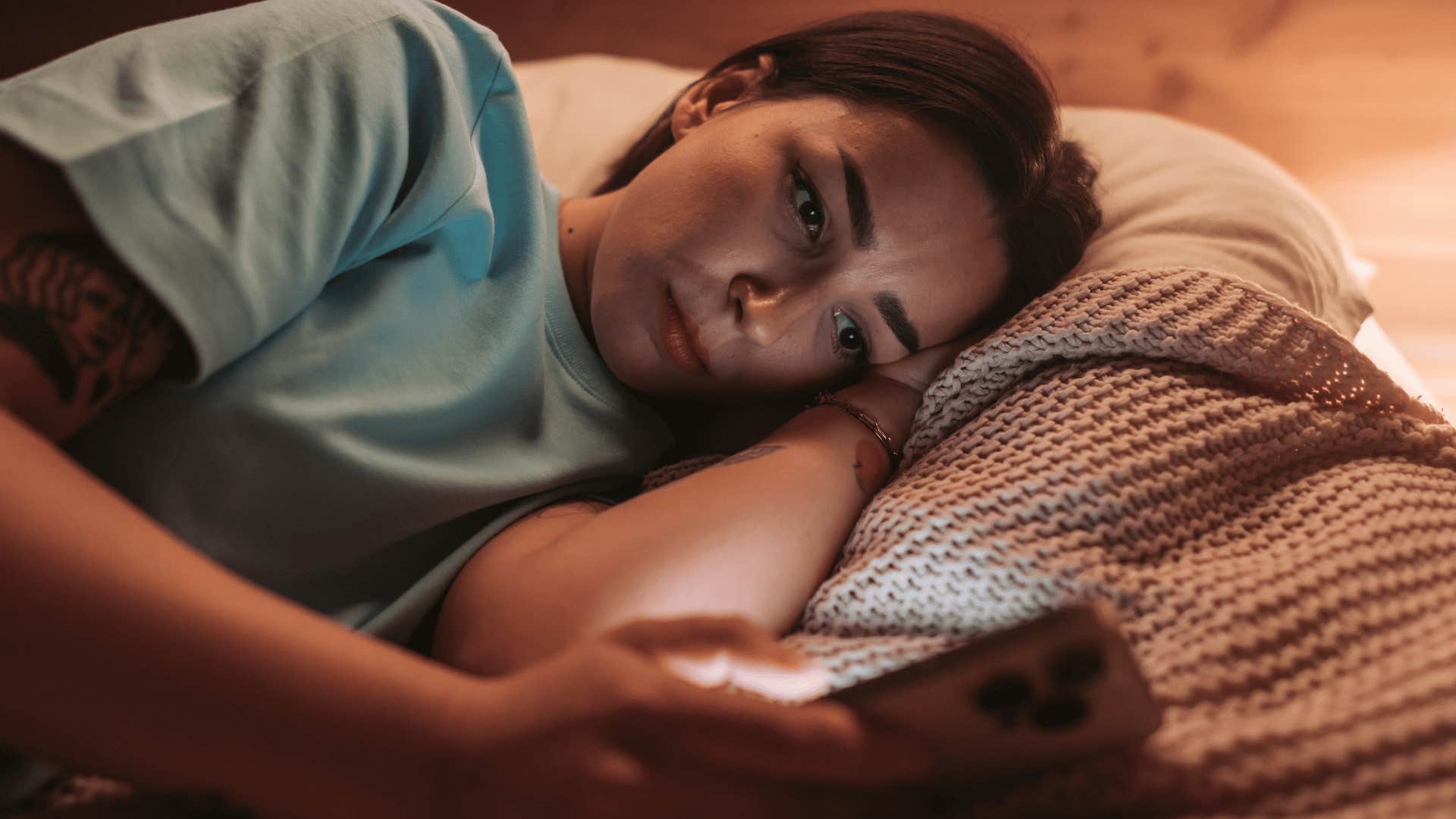 woman not doing okay isolating herself in bed alone