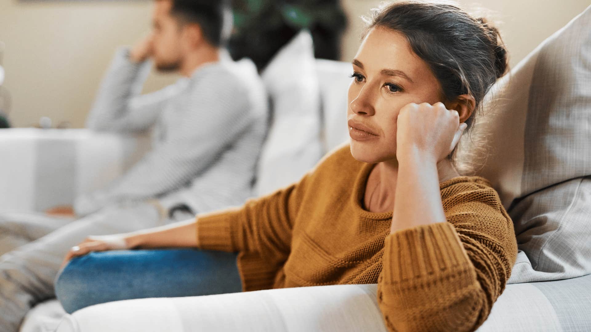 stressed woman getting easily frustrated next to partner