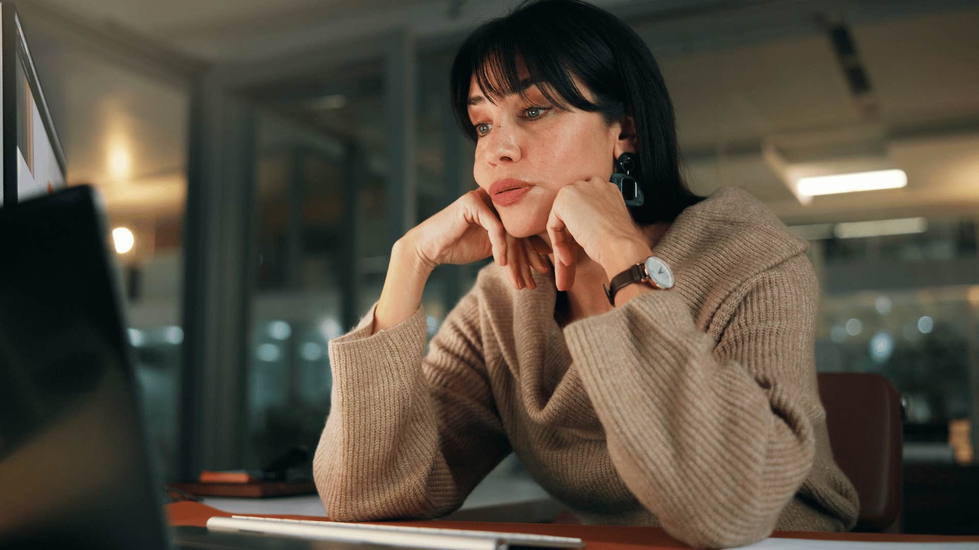 sad woman working all the time in a dark office