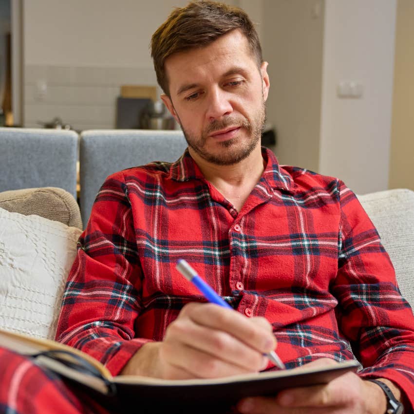 smart man journaling at home after changing into pajamas