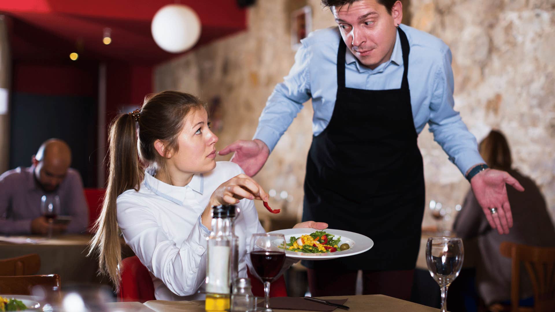 woman acting disrespectful to waiter