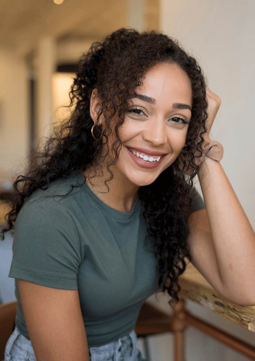 smiling woman accepting that people will be doing better than her
