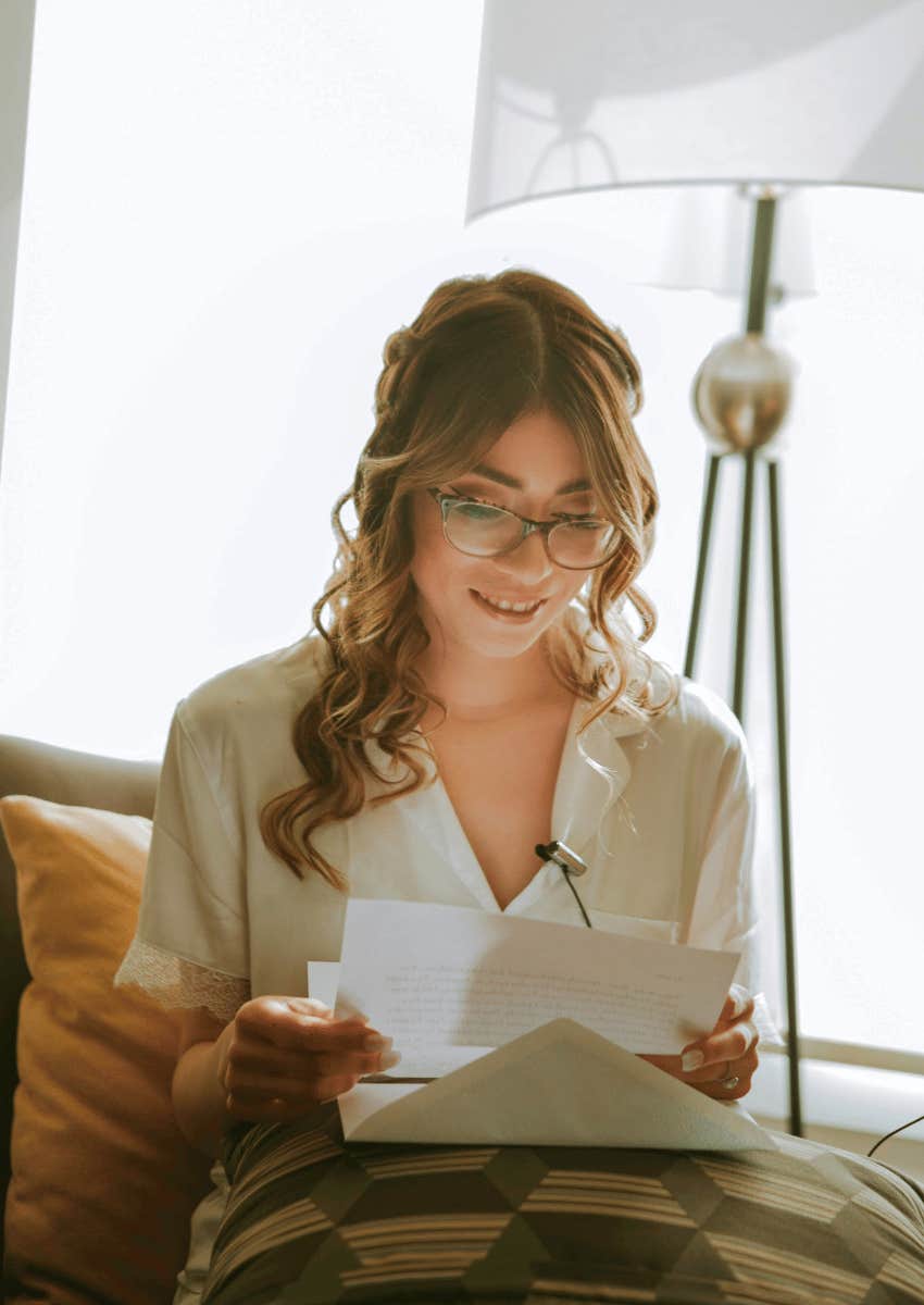smiling woman reading letter