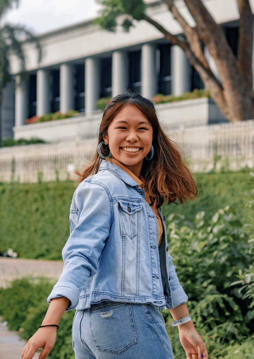 smiling young woman staying in the present