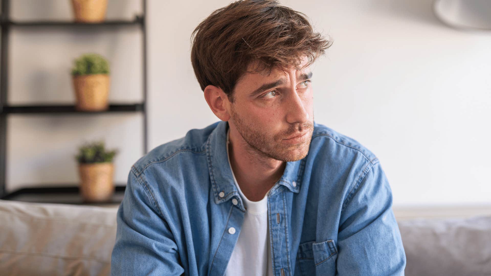 sad man holding in emotions internally