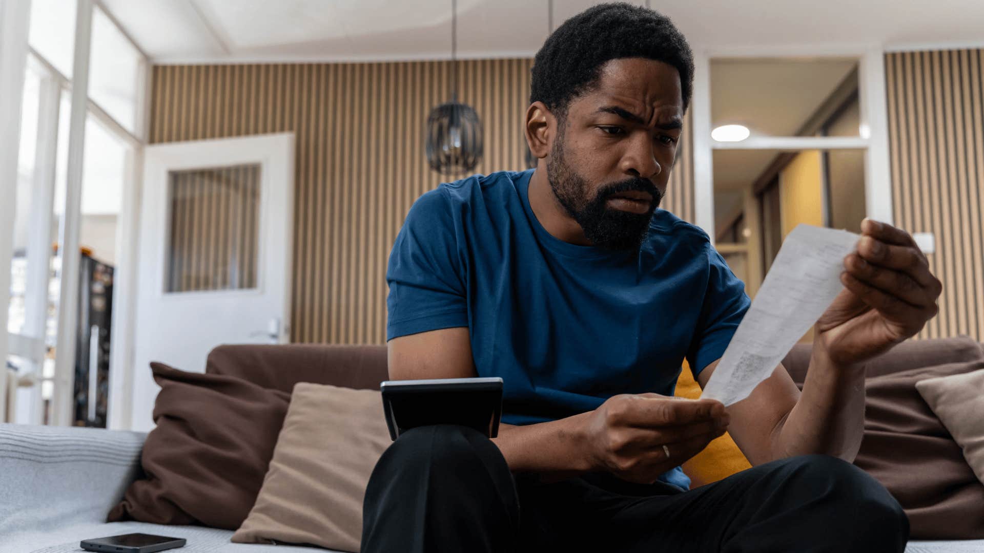 man dealing with a pressure to provide looking at bills