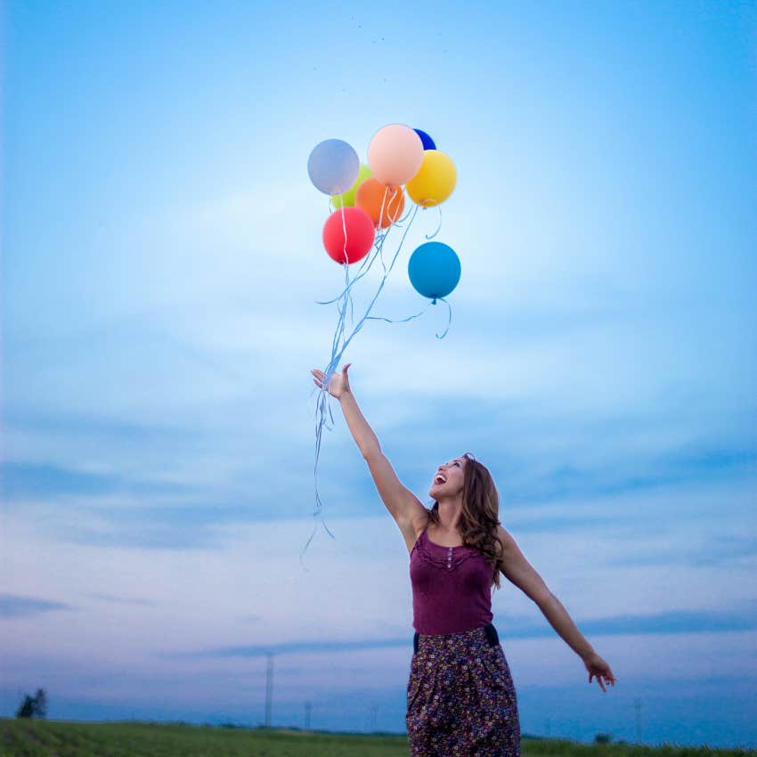 woman engaging in the socially acceptable habit of releasing balloons