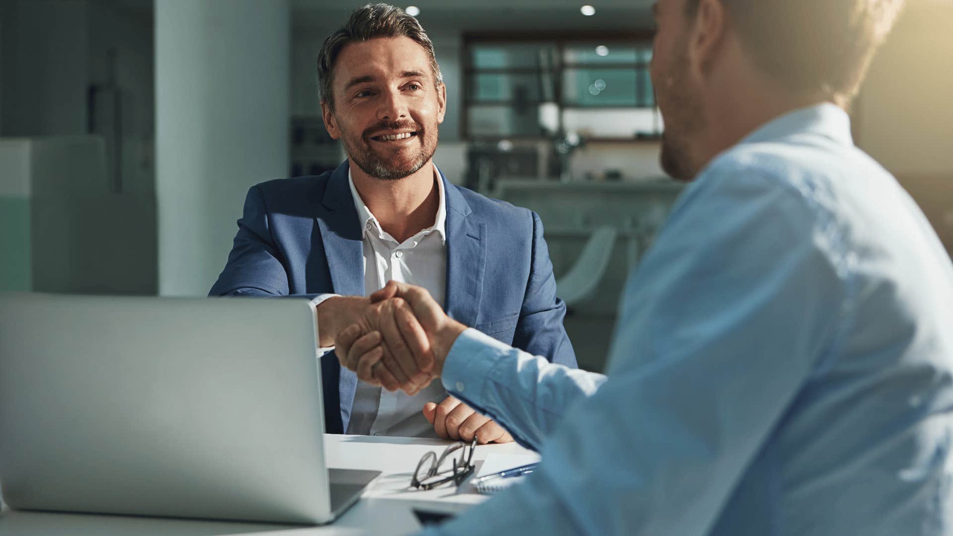 men shaking hands with colleague as a show of respect