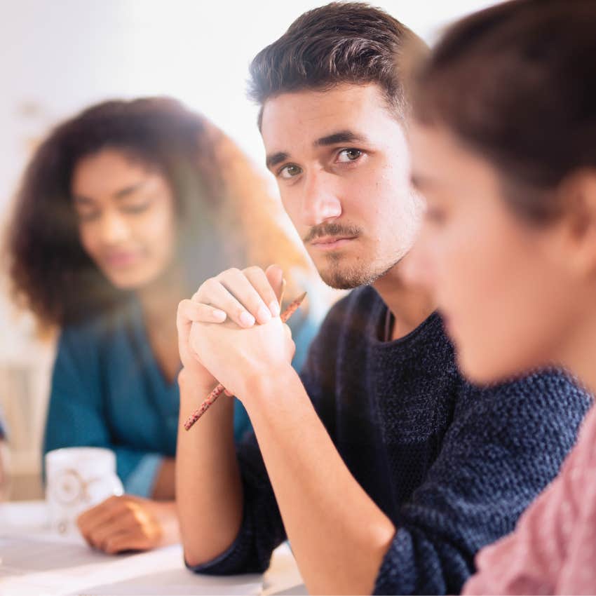 man in a work meeting feeling left out by colleagues