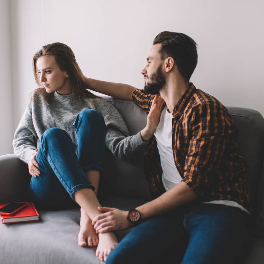 unhappy woman pushing away manipulative man fake praising her