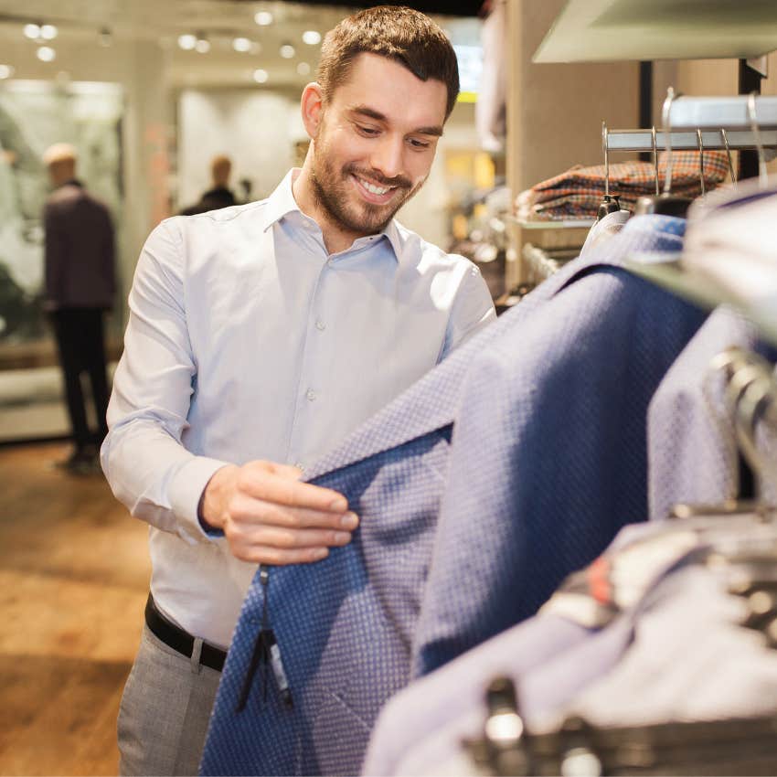 man spending money on suits at store