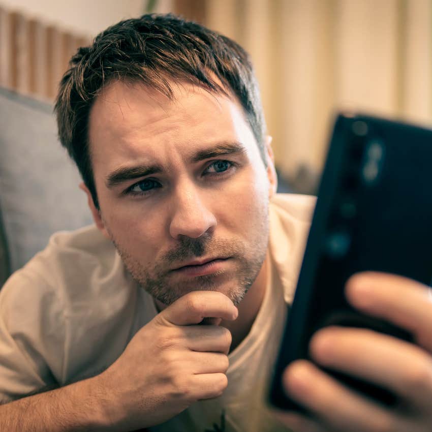pensive man looking at his social media accounts on his phone
