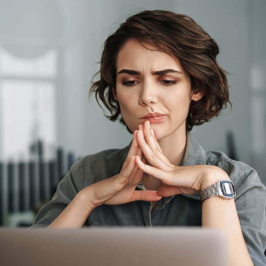 smart woman looking at her computer trying to focus