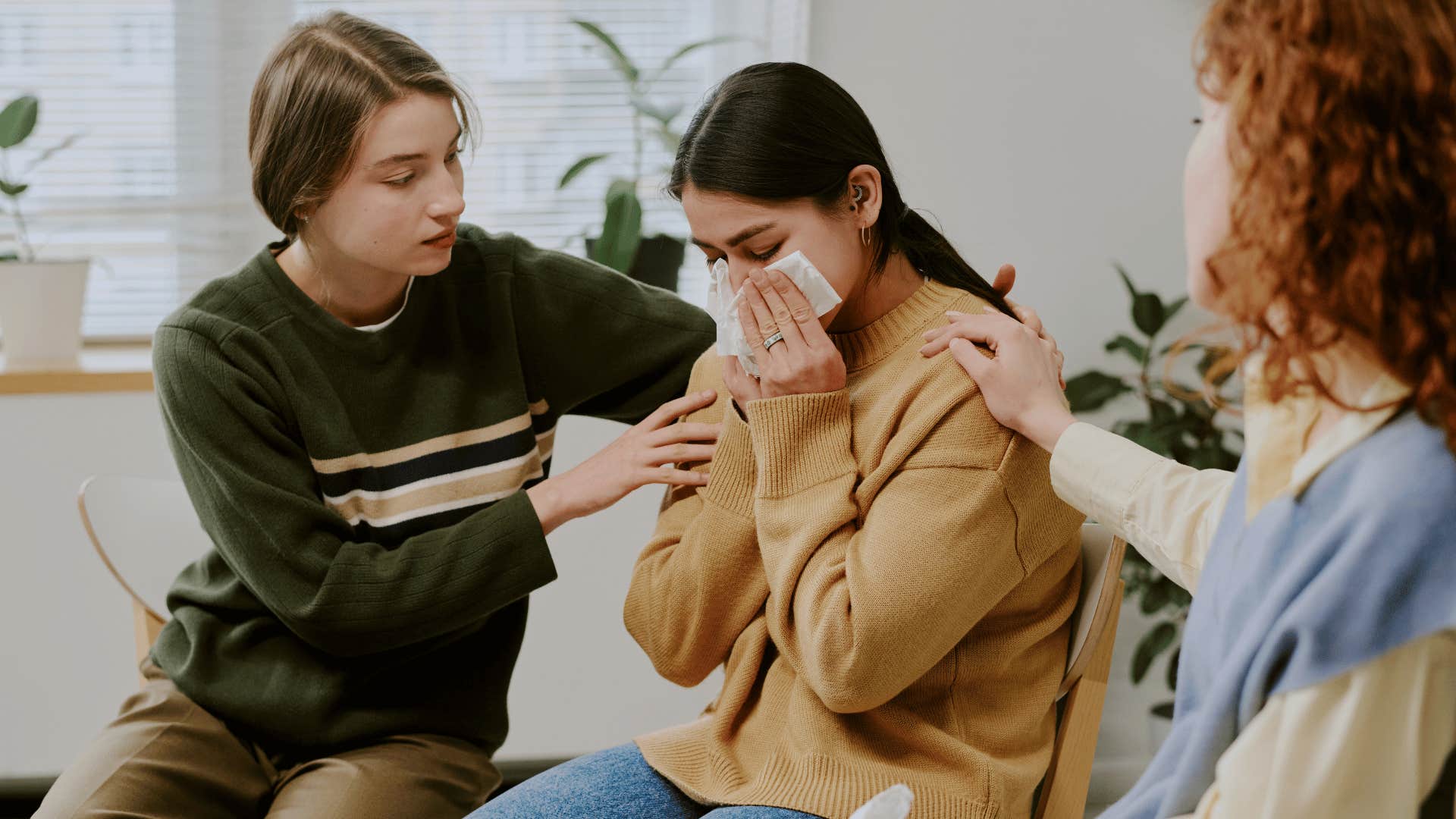 two friends comforting woman asking how can i support you