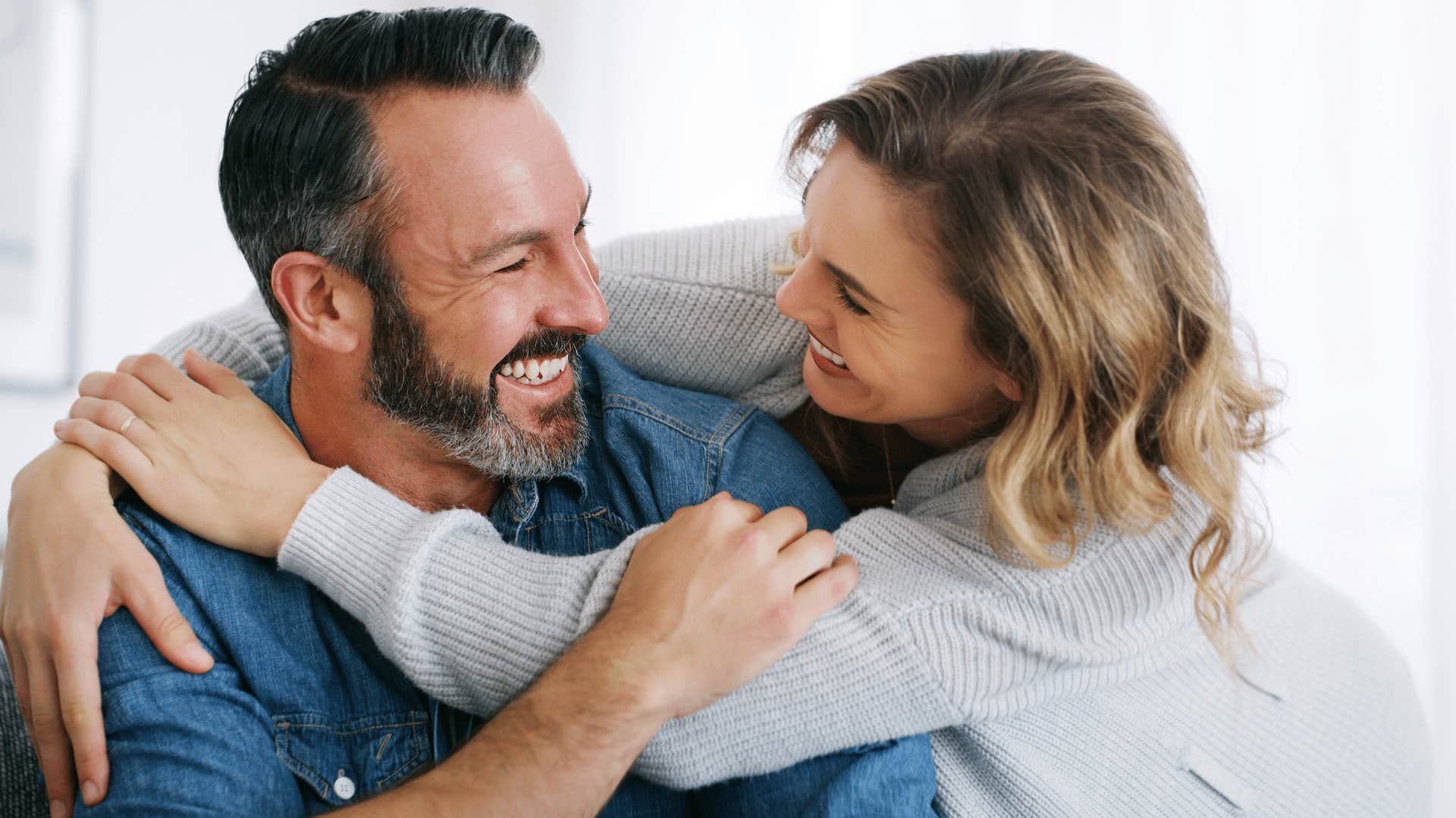 kind woman smiling hugging man telling him i'm here if you need anything