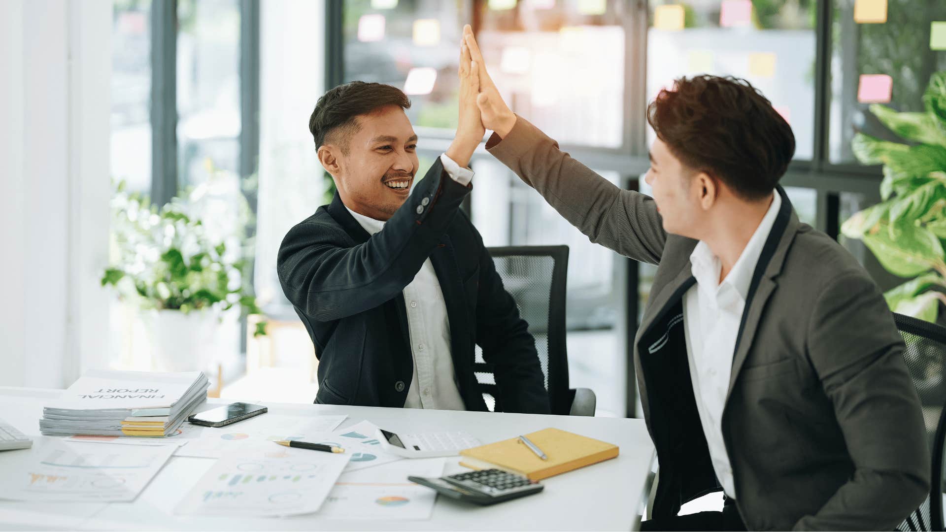 colleagues high-fiving saying great job to each other