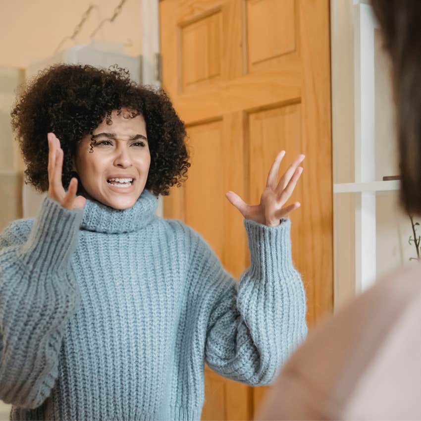 Person looking visibly upset during a conversation while describing a minor disagreement as emotionally triggering