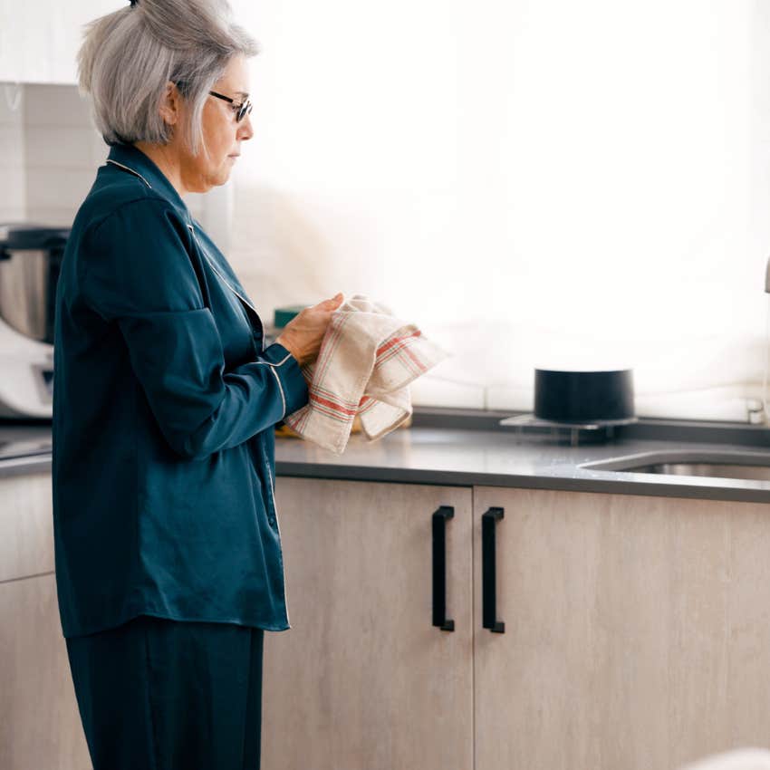 boomer woman washing dishes without complaining