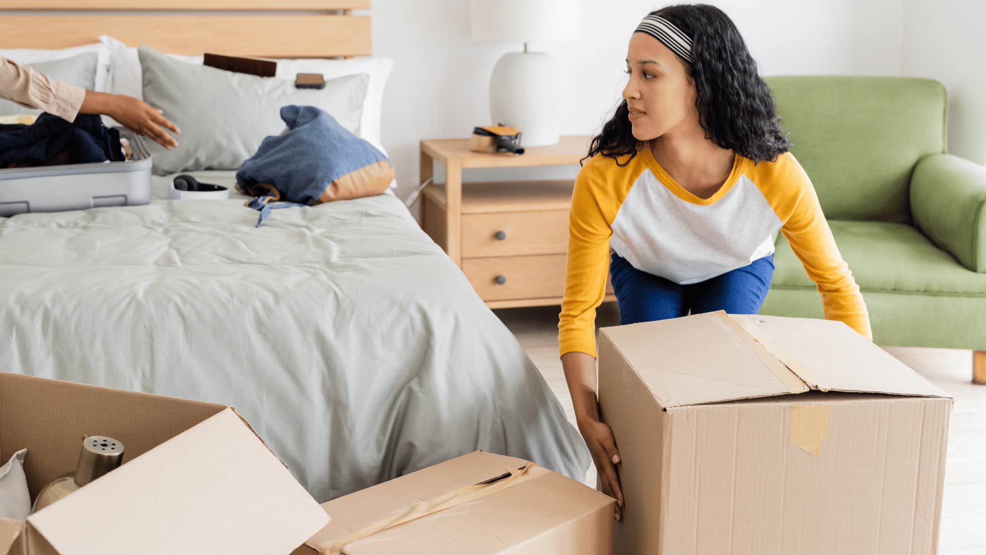 young woman living independently unpacking in home