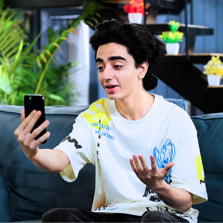 Gen Z man being natural in front of a camera making a video