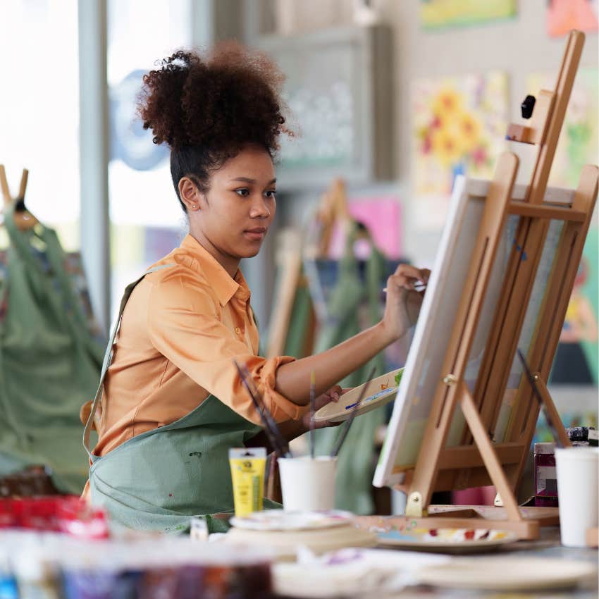 interesting woman being creative by painting