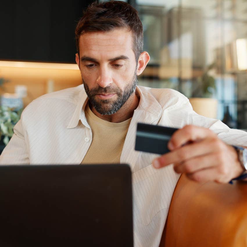 man giving into toxic consumerism by online shopping
