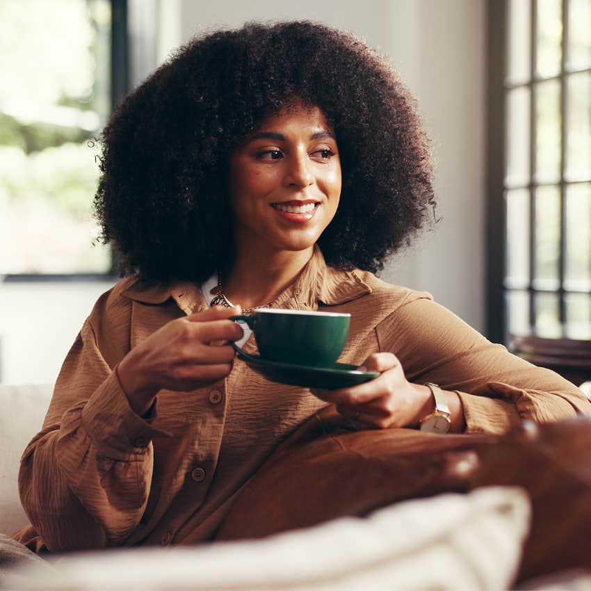 pensive intelligent woman thinking about the future while drinking tea