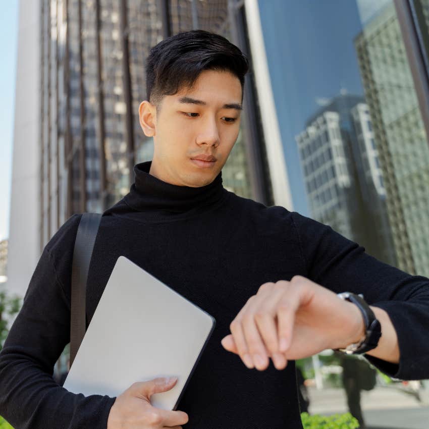 intelligent man checking his watch managing his time properly