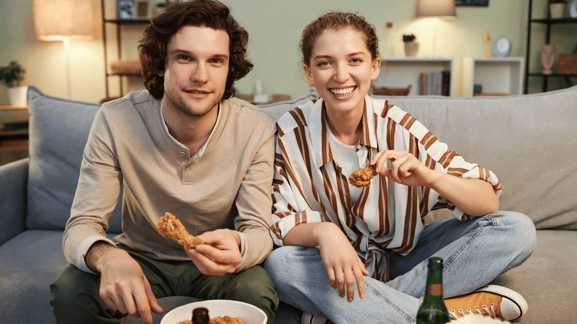 couple sitting on couch having a homemade meal