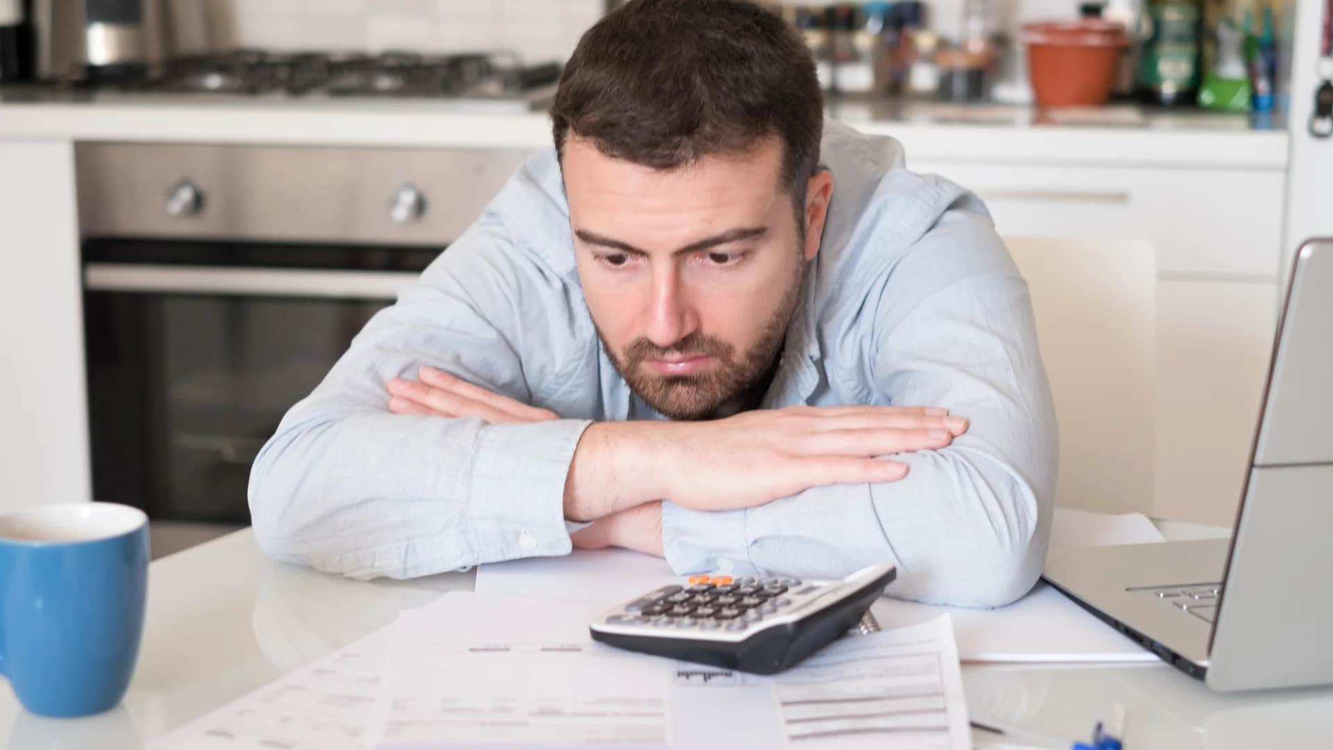 broke man struggling to manage his finances doing bills