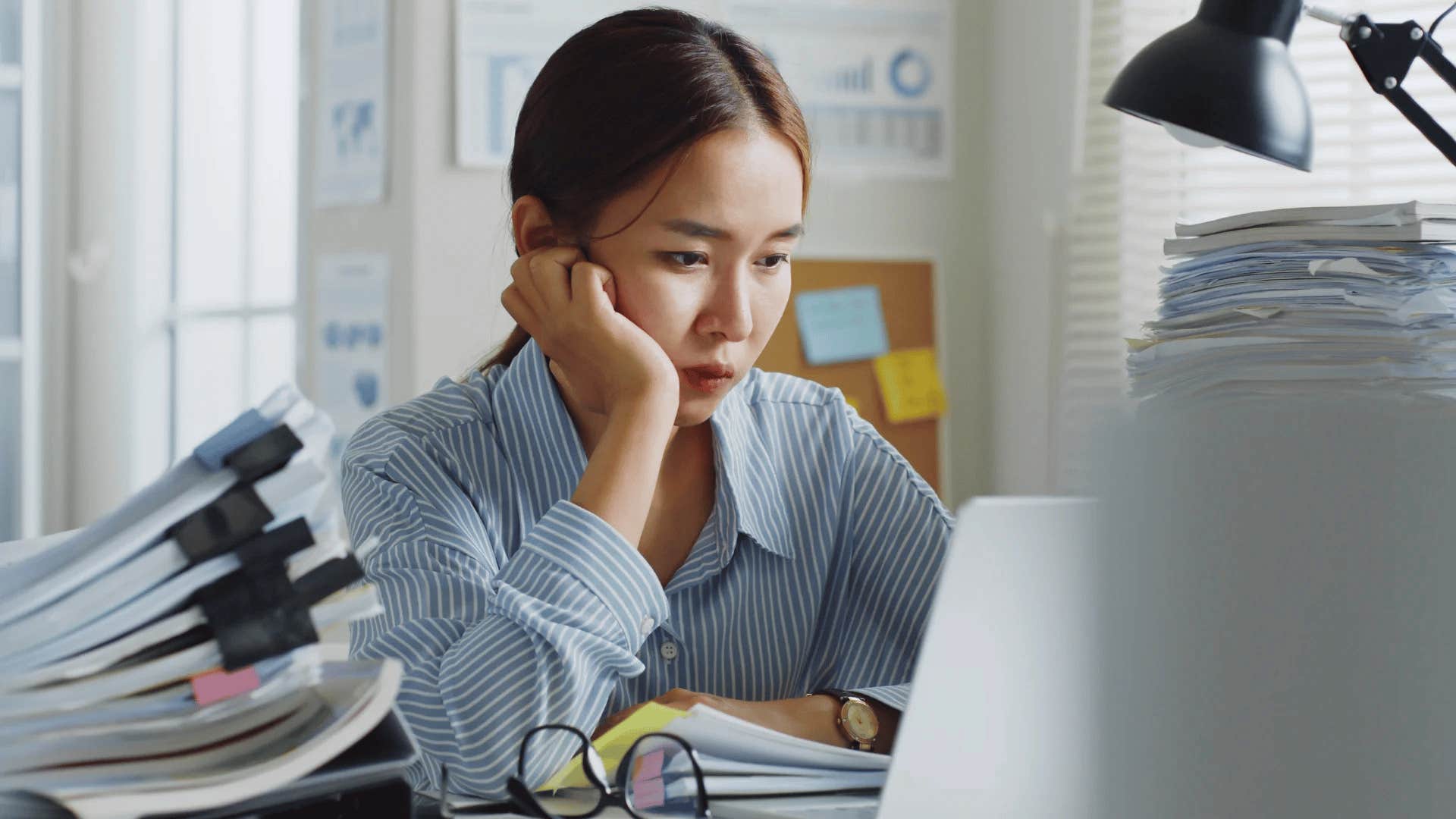 overachieving woman looking stressed at work