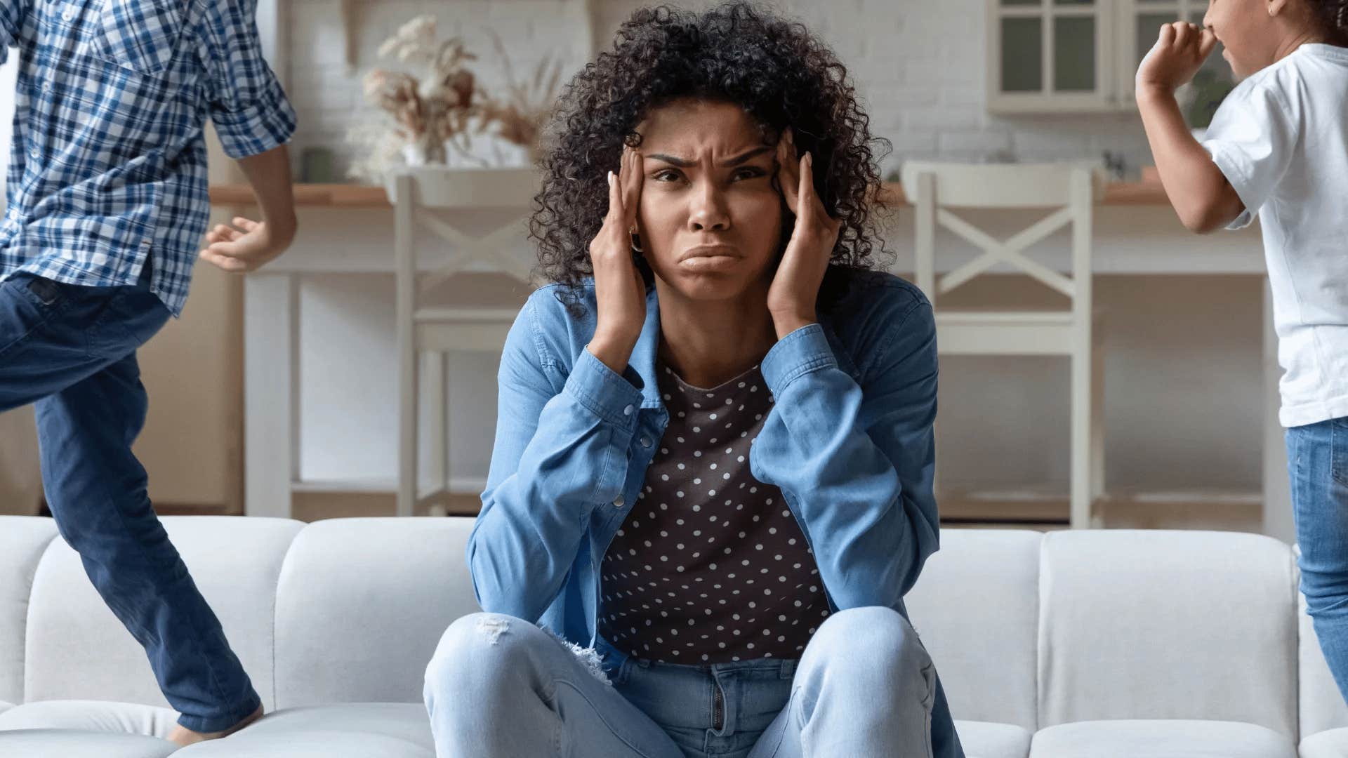 stressed woman trying to watch her rambunctious kids