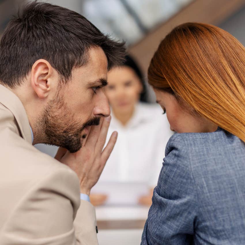 man entertaining drama and gossip at work with colleague