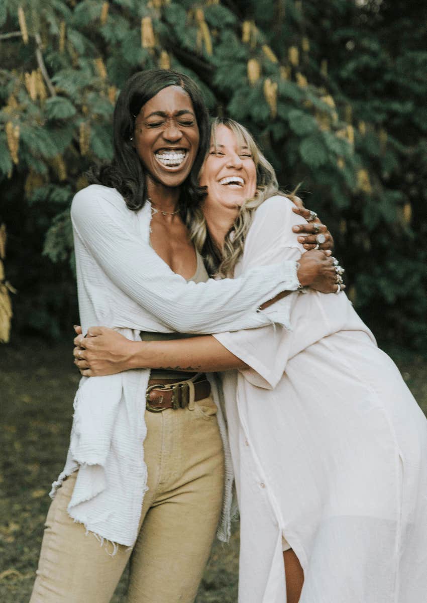 two smiling women with a heart connection