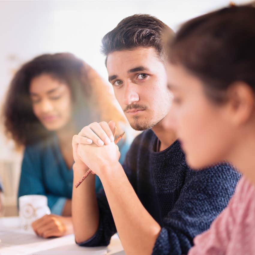 annoyed gen z man in the office not enjoying traditional structures in place
