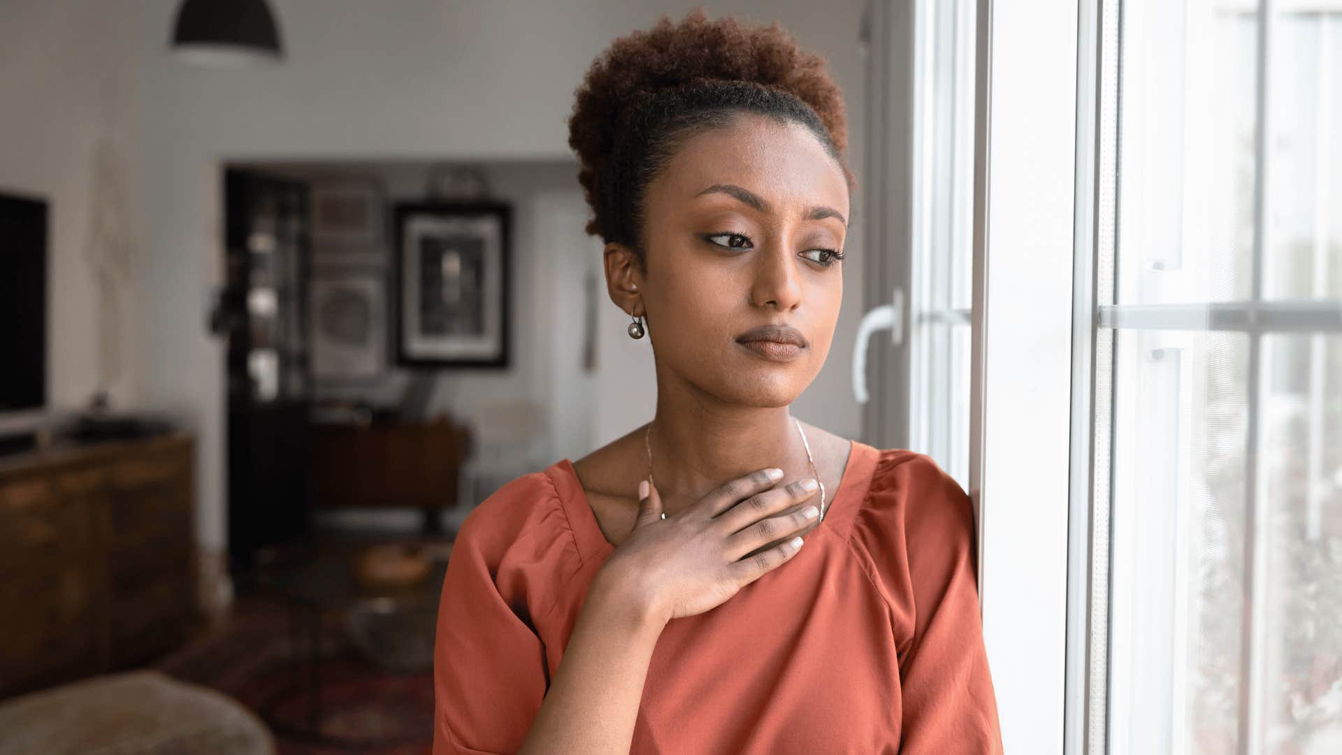 sad woman looking outside saying i don't fit in anywhere to herself