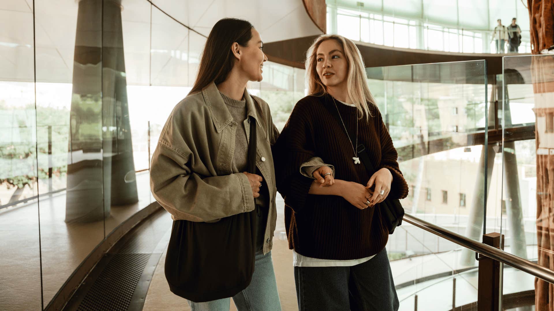 woman talking to insecure friend walking around the mall