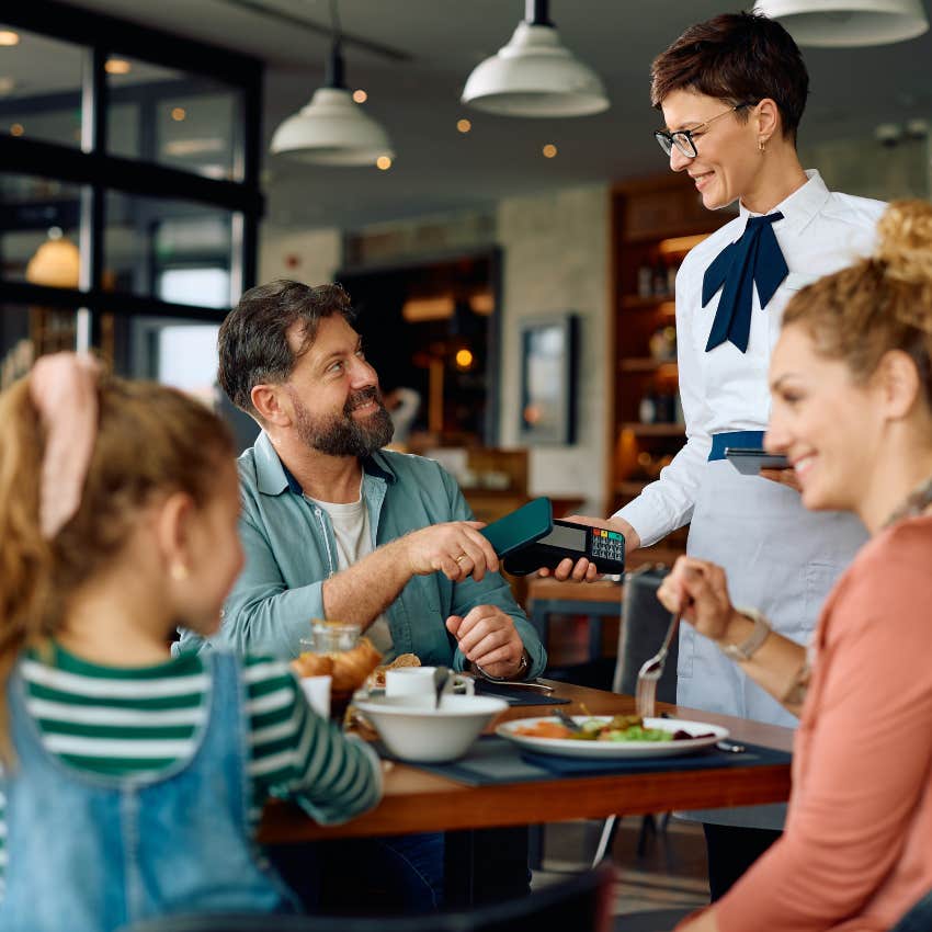family eating out at restaurant
