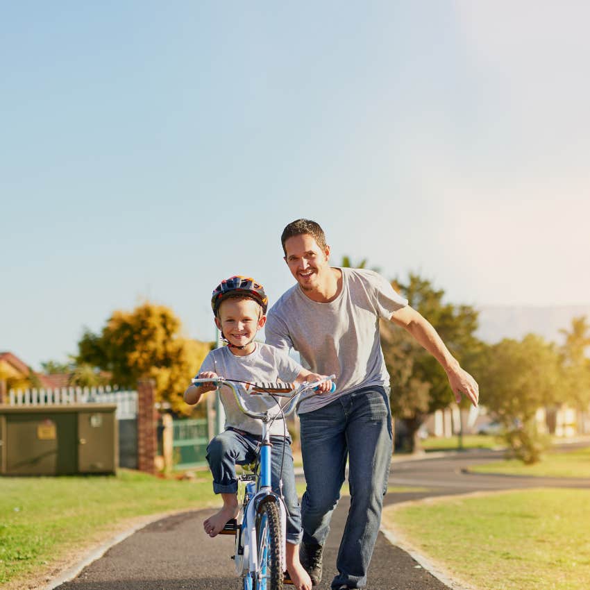 father spending quality time with son on a bike