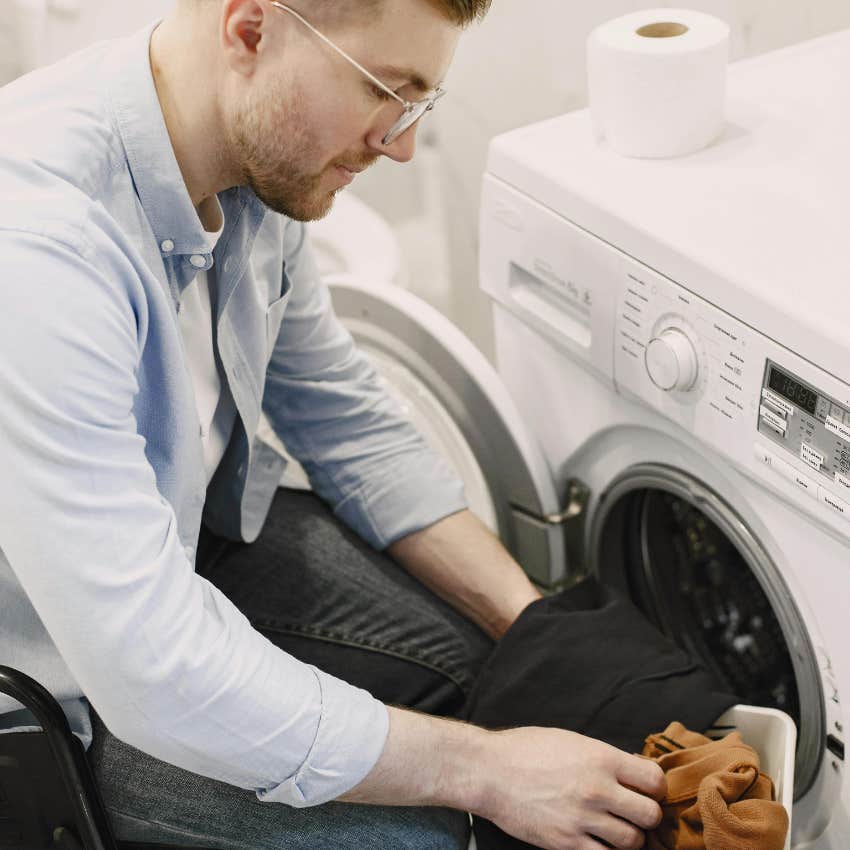 man doing laundry to wash his towels weekly