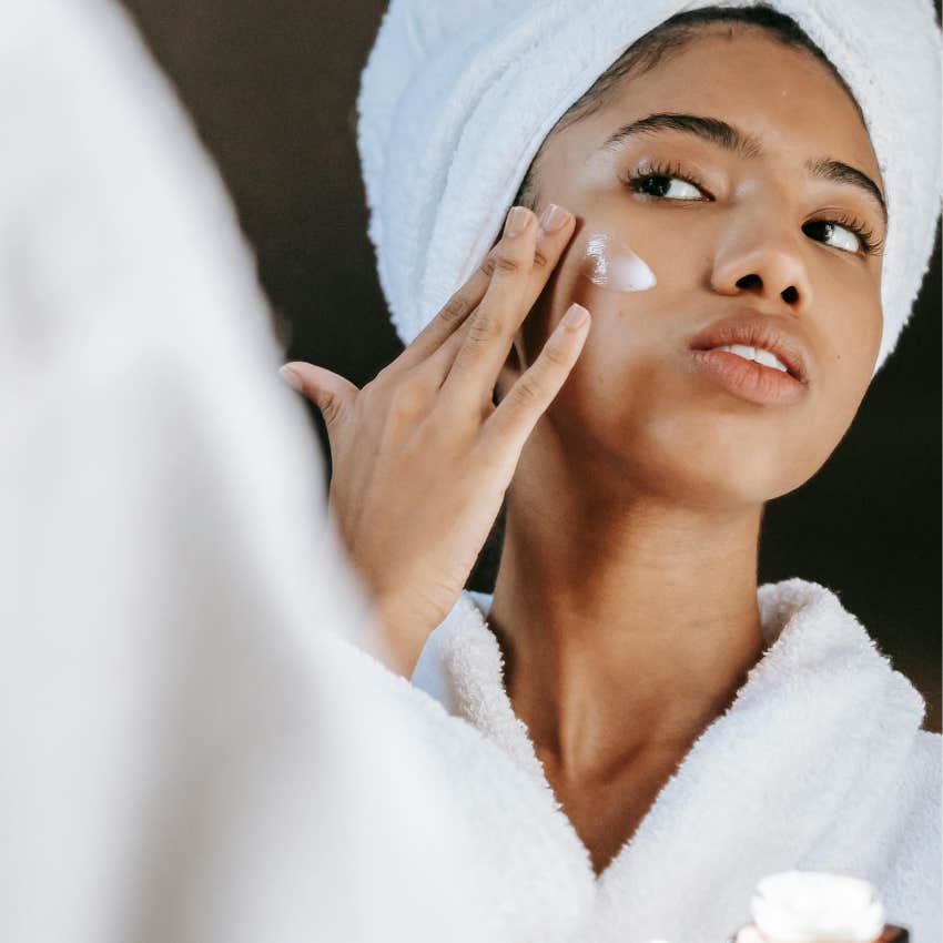woman using multiple clean towels for her self-care routine