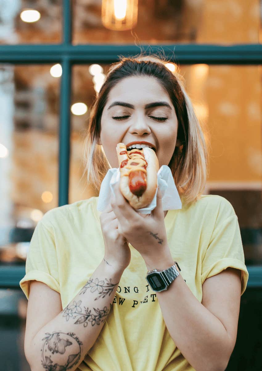 woman eating a hotdog