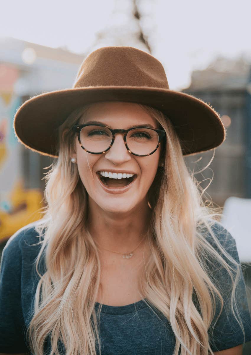 woman in glasses smiling and living in the present