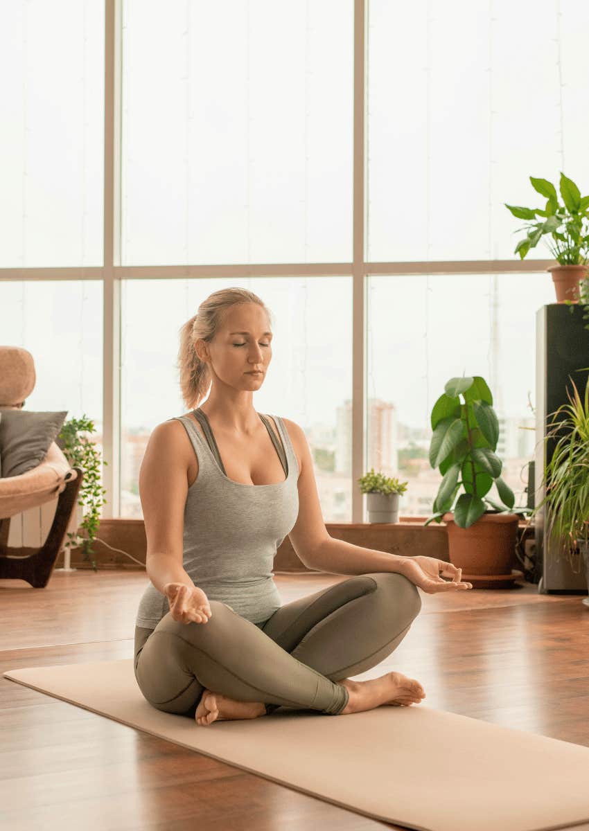 woman meditating on a yoga mat