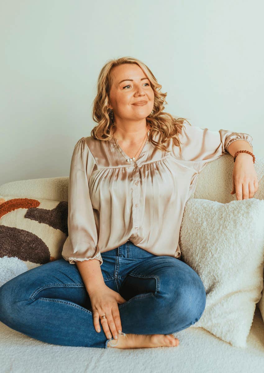 woman smiling softly thinking about what makes her happy