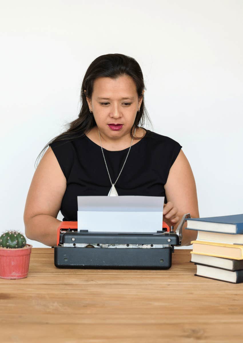 woman writing a story on a typewriter