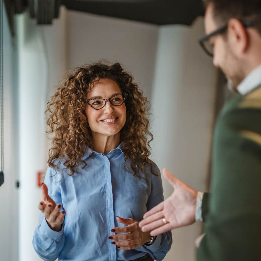man excitedly telling male colleague nice work