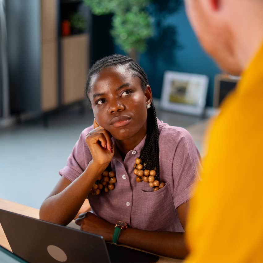 woman with exceptional inner strength listening calmly while a coworker speaks condescendingly
