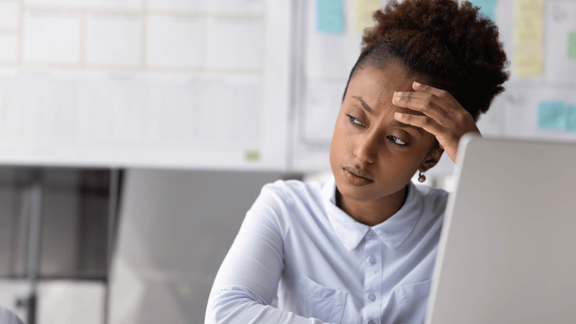 observant woman at work thinking deeply